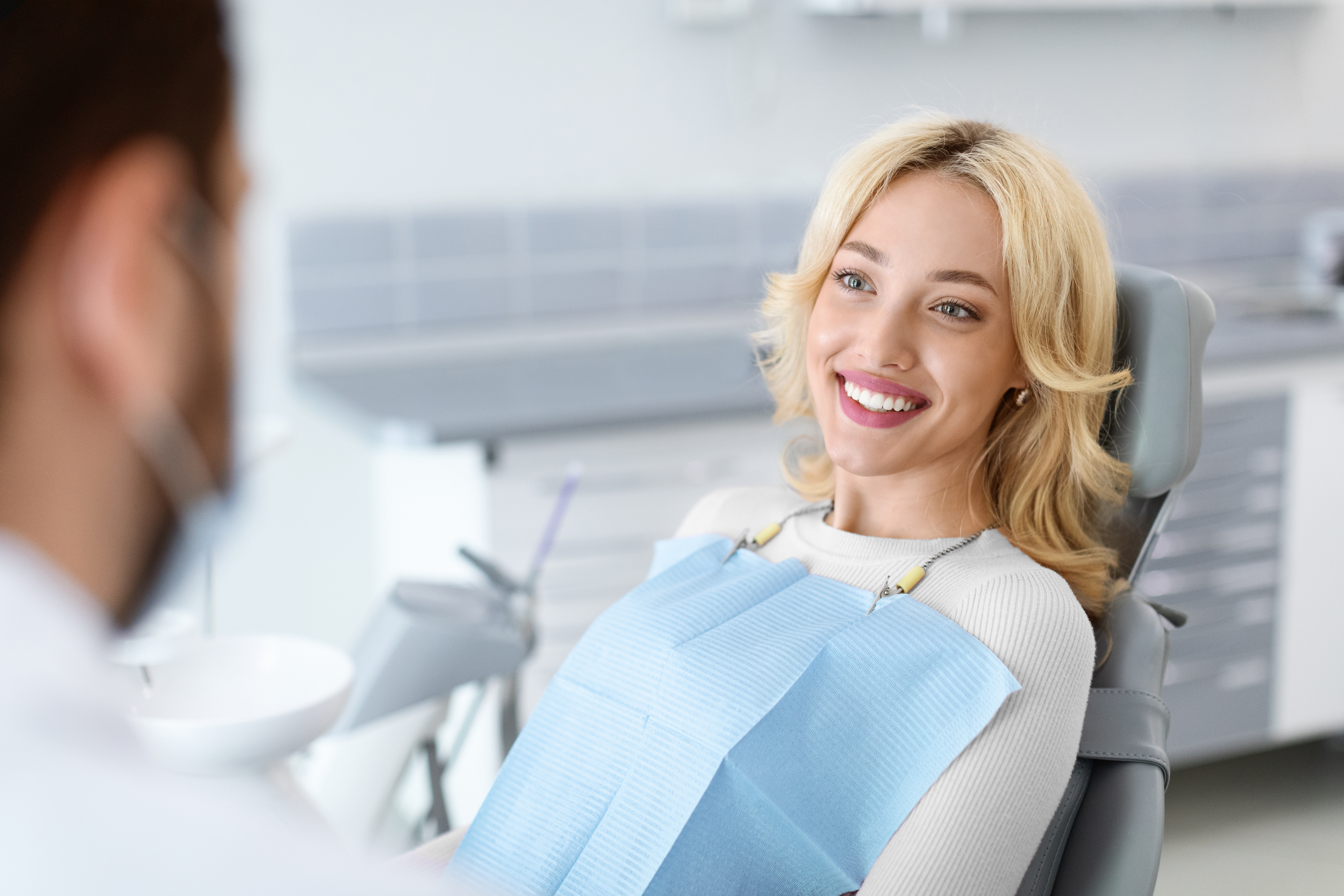 younger couple hugging inside | dentist dedham ma